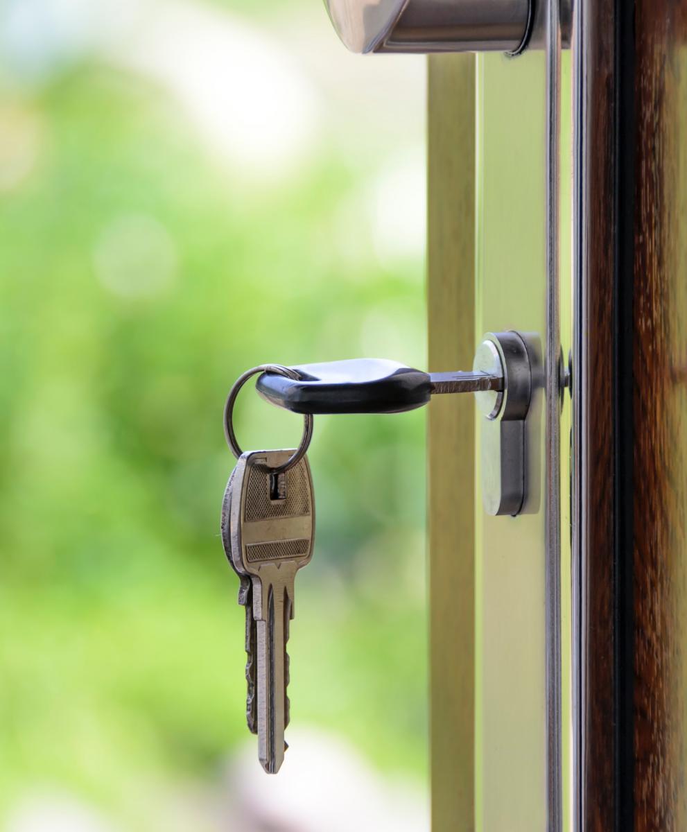 key unlocking door - door is open showing outdoors