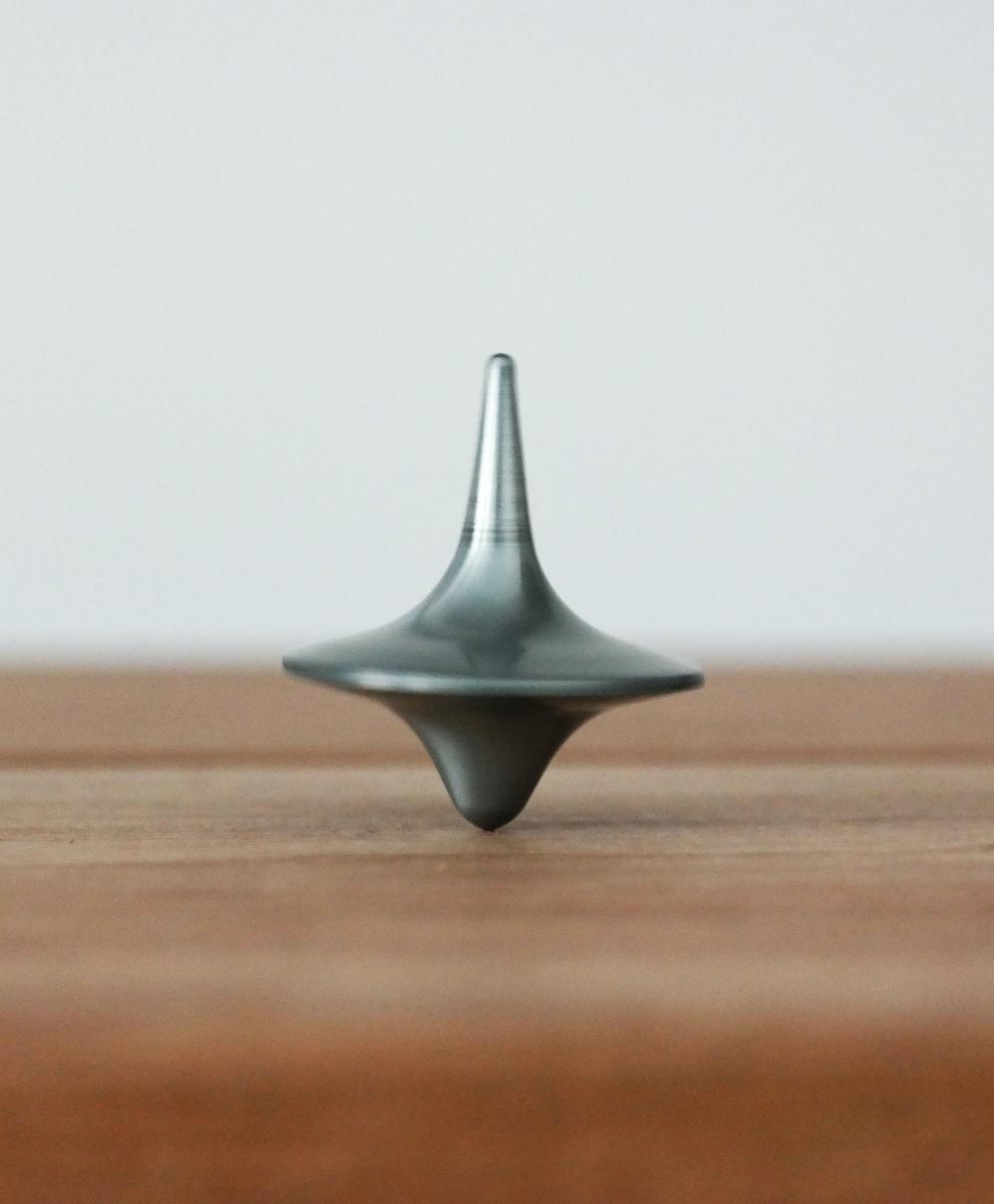 Balanced grey top on wooden table