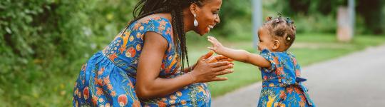 woman and child smiling at each other.